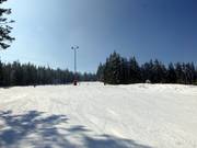 Brede en vlakke afdaling in het bovenste gedeelte