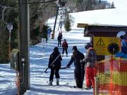 Het personeel helpt bij het instappen bij de sleeplift.