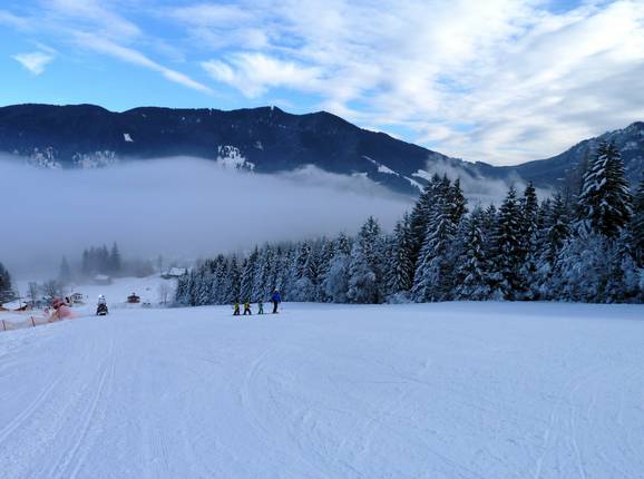 Brede afdaling door het bos met Oberammergau in de mist