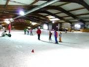 Vlakke beginnerspiste bij de ingang van de skihal